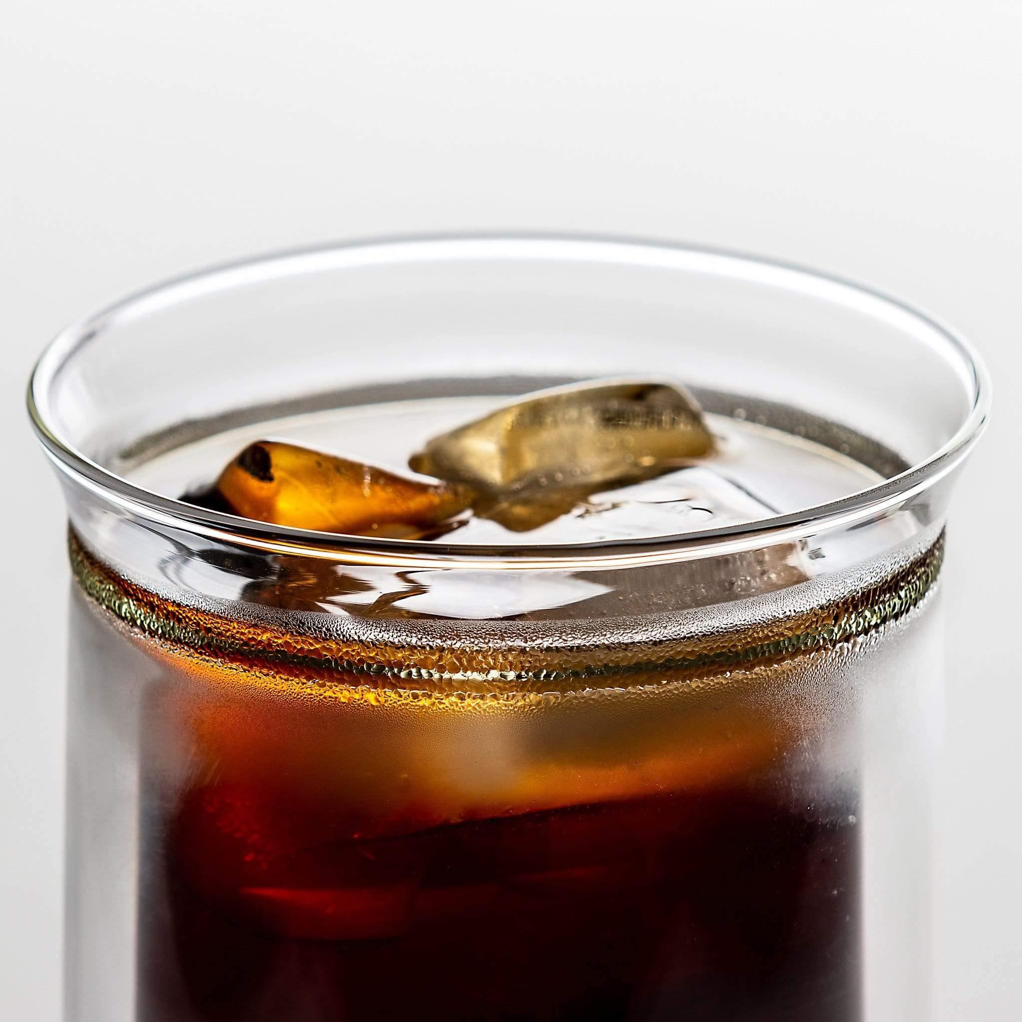 Double wall glass placed next to coffee beans and scoop