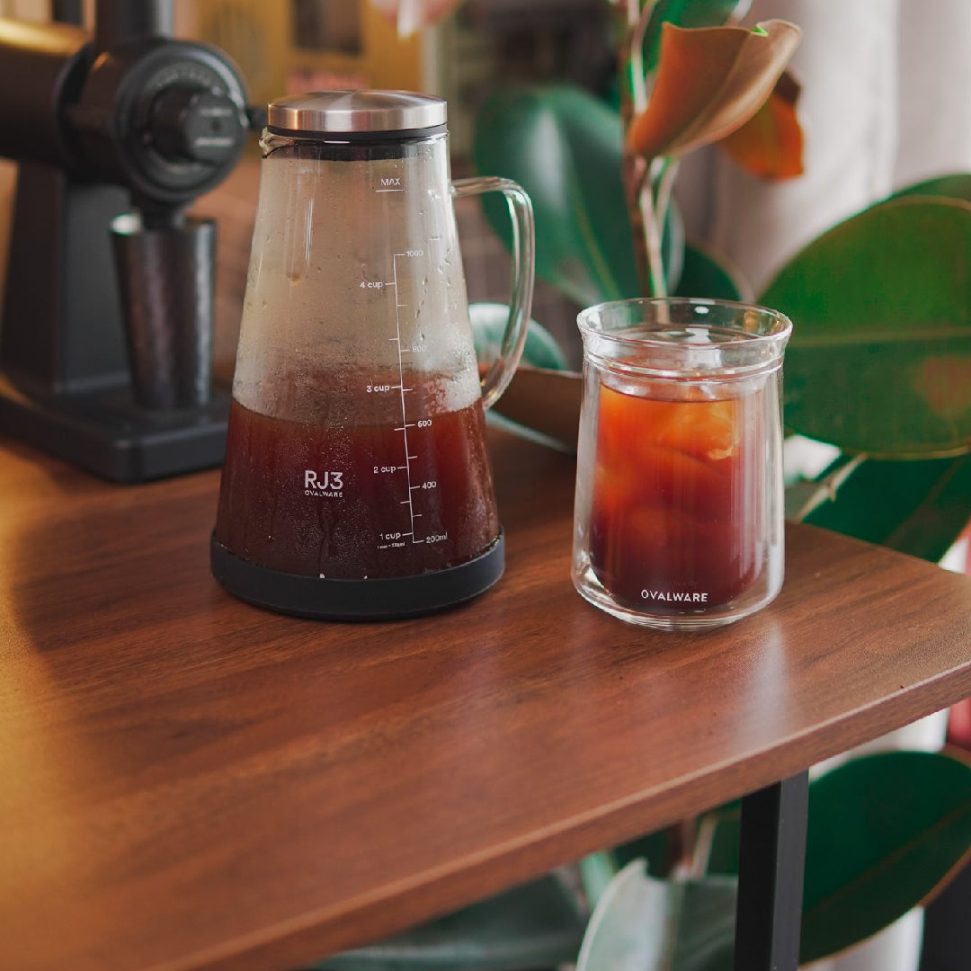 Cold brew coffee maker with a double wall coffee glass on a kitchen counter