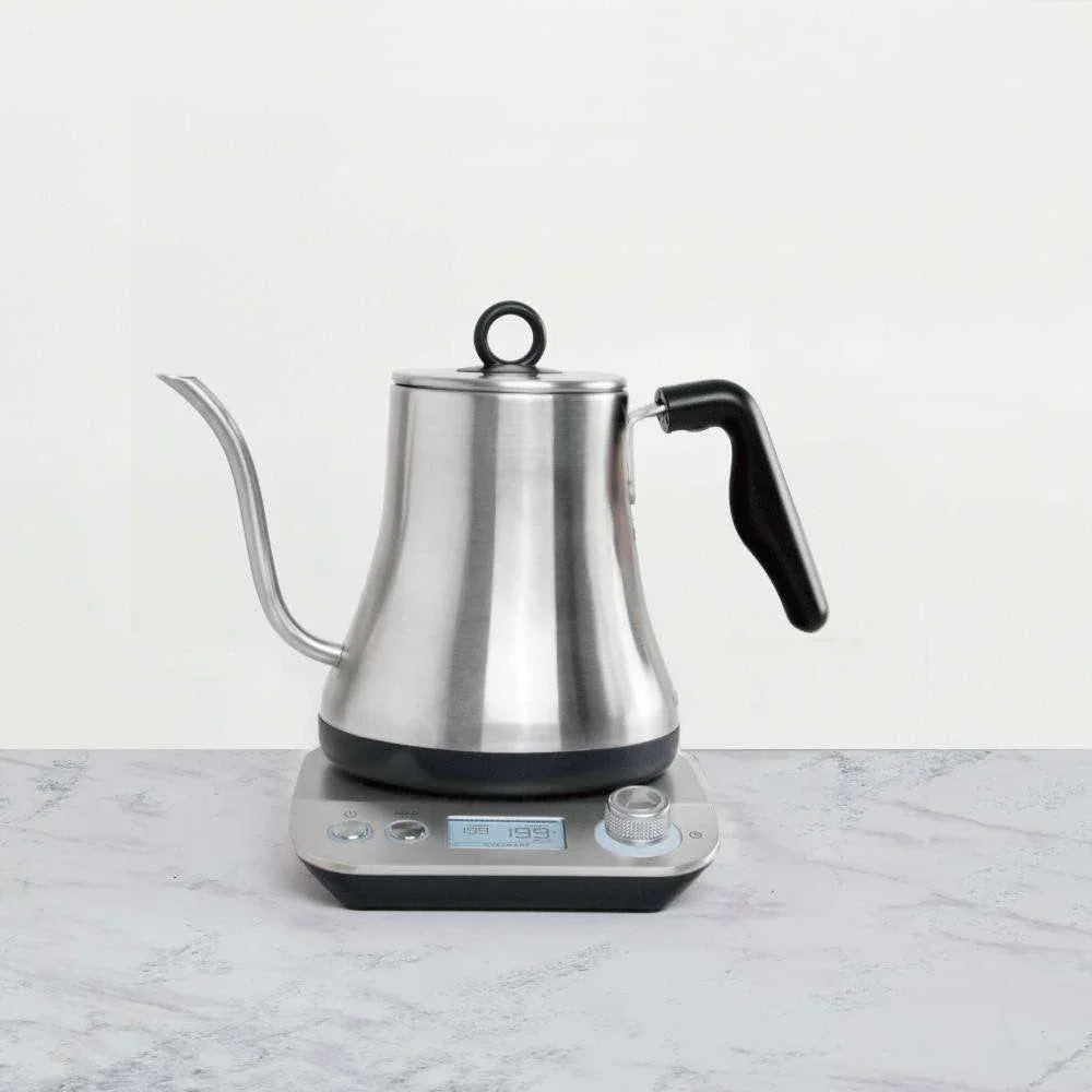 Kettle placed on kitchen counter next to coffee-making accessories