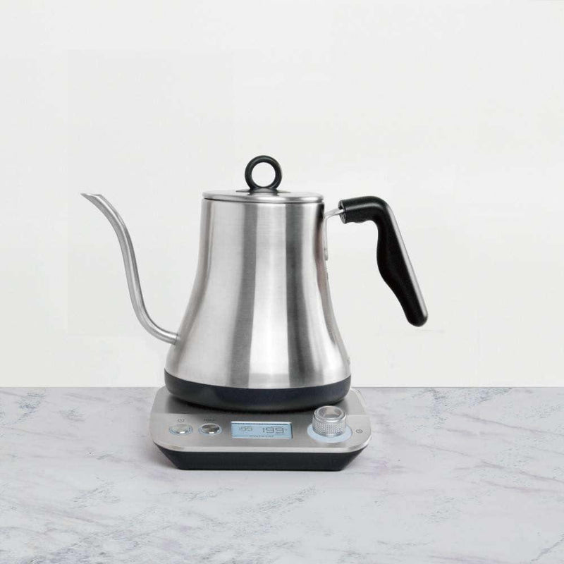 Kettle placed on kitchen counter next to coffee-making accessories