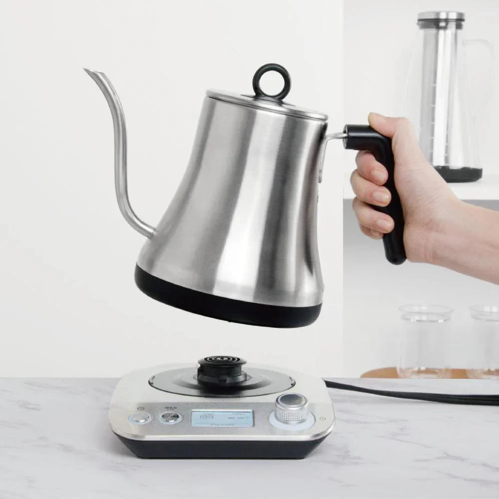 Kettle placed on kitchen counter next to coffee-making accessories